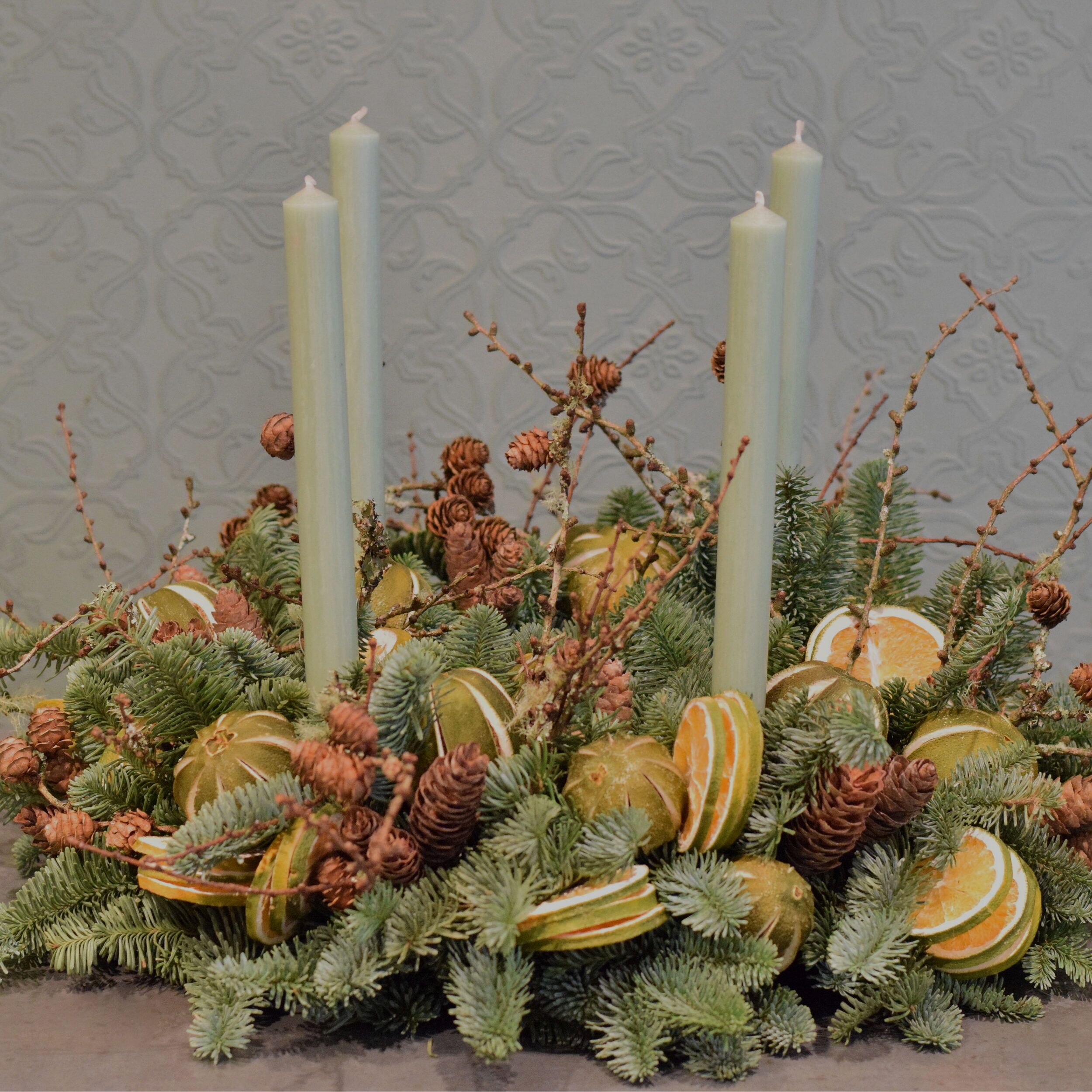Charles advent wreath, green fruits, cones and textures Sample of the luxury Charles advent wreath, green fruits, cones and textures available from Kensington flowers London