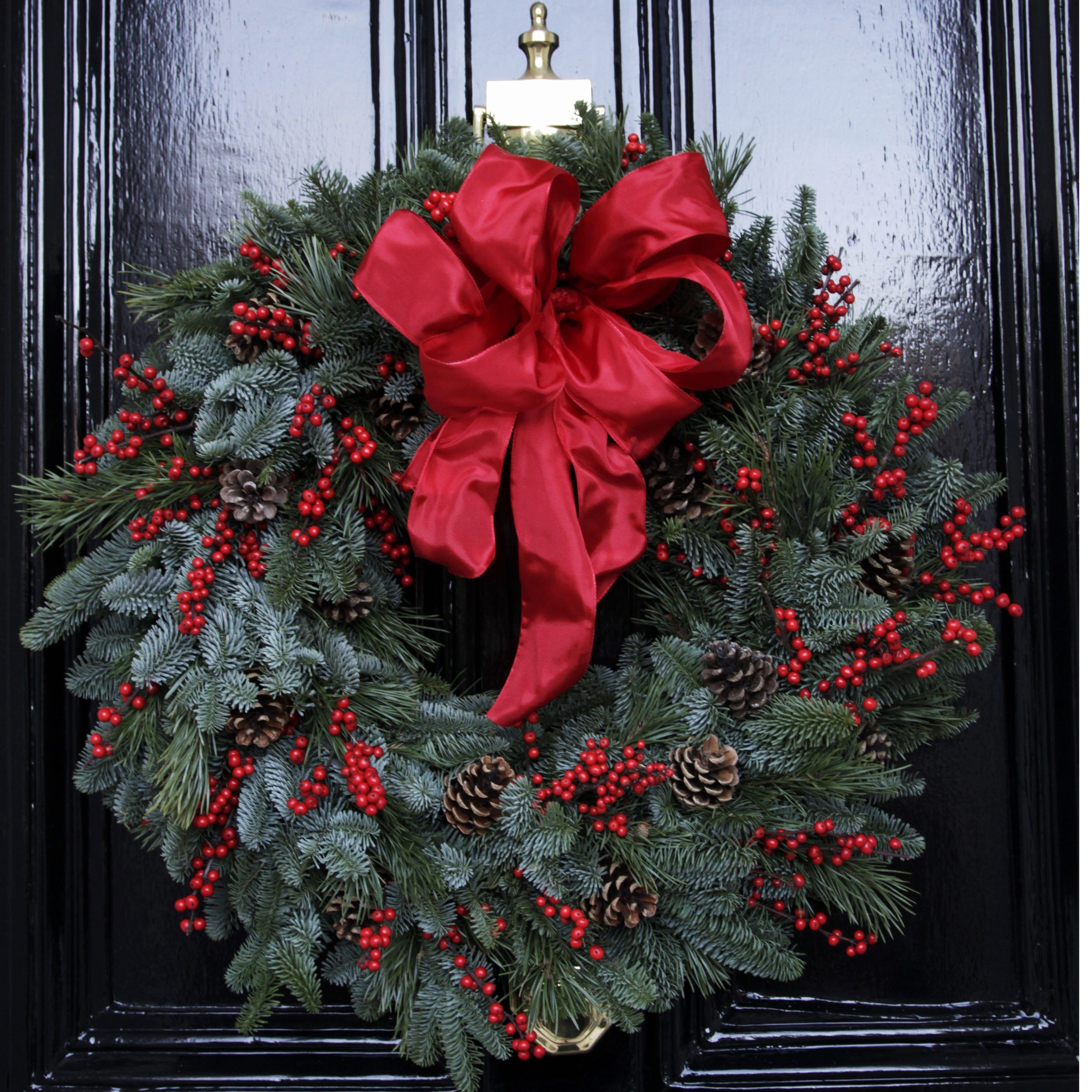 The Albert Christmas Luxury Wreath Photo showing a sample of The Luxury Albert Christmas door wreath, a fresh pine and red berry wreath available to order from Kensington Flowers London